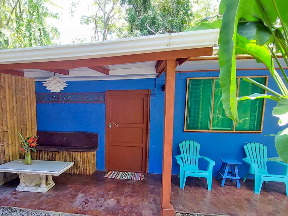 First sight of the Bungalow from the garden path — your own gate and dedicated parking spot